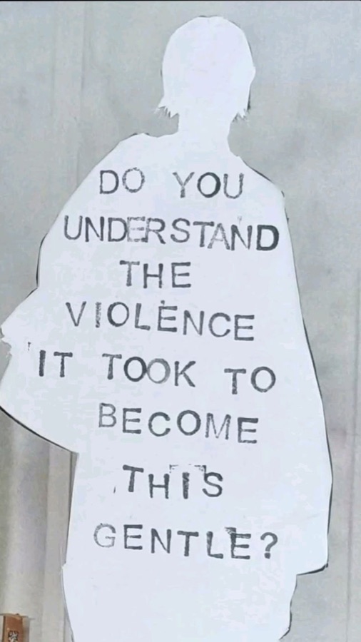 Paper silhouette with text asking do you understand the violence it took to become this gentle