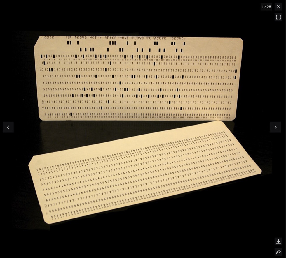Two punched cards on a dark background