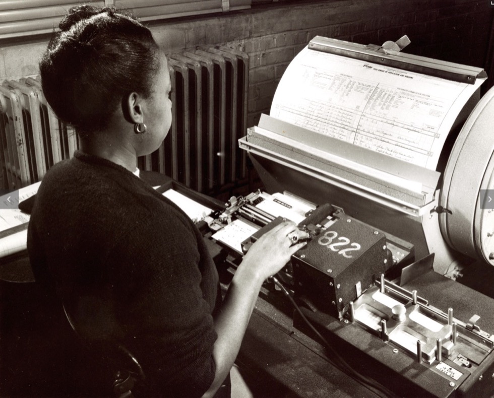 A person using a keypunch machine